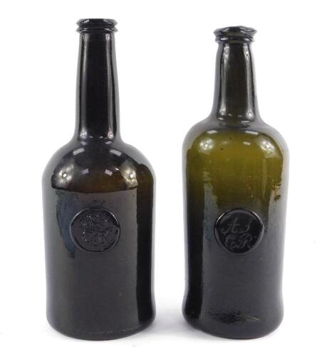 Two early 18thC green glass seal mallet shaped wine bottles, each bearing circular seals with initials ASCR, 26cm and 27cm H.