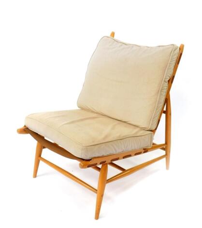 A 1950's Ercol Easy chair, designed by Lucian Ercolani, beech framed with a fitted cushion back and loose cushion seat.