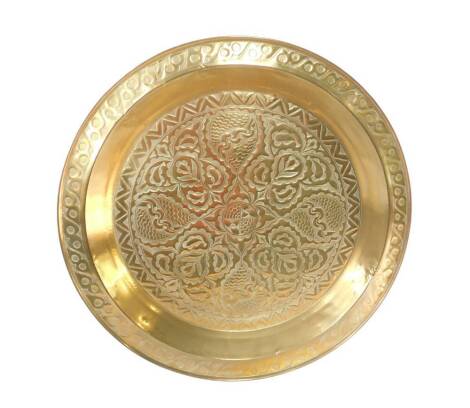 A large Arts & Crafts style brass table tray, embossed and hammered with stylised floral and foliate motifs, within a repeating figure of eight border, 90cm Dia.