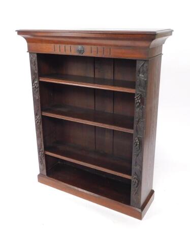 A Victorian oak open bookcase, the outswept pediment over three shelves flanked by vine carved supports, raised on a plinth base, 129cm H, 103cm W, 34.5cm D.