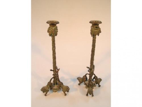 A pair of antique cast bronze candlesticks