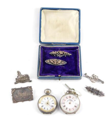 Two late 19thC lady's pocket watches, open faced, one keyless wind, one keywind, dials bearing Roman numerals, cases marked 935 and 800 respectively, and five Victorian silver brooches, including one bearing the crest of the Lincolnshire Regiment, and ano