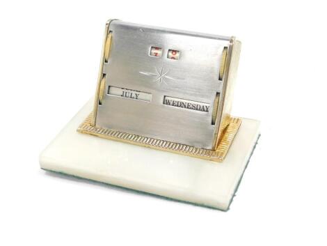 A late 20thC perpetual desk calendar, raised on a rectangular perspex base, 11cm W.