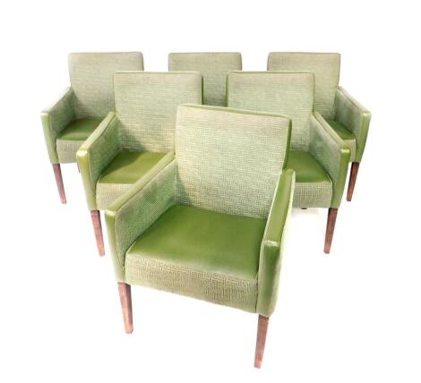 A set of six mid 20thC style pub armchairs, upholstered in green leatherette and Greek key fabric upholstery, raised on tapering square legs. The upholstery in this lot does not comply with the 1988 (Fire & Fire Furnishing) Regulations, unless sold to a k