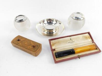 An Edward VII cut glass match striker, with silver mount and stand, London 1908, George V cut glass match striker with silver mount, Birmingham 1911, a cheroot holder, case marked for Alfred Dunhill Ltd, and a late 19thC carved novelty wooden box engraved