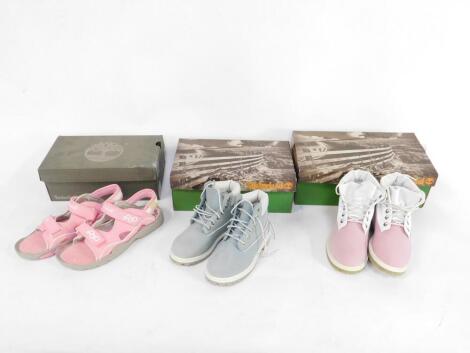 Two pairs of Timberland Youth's Roll Top pink shoes, UK sizes 12 - 2, together with a pair of pale blue Youth's boots UK size 12, and a pair of Timberland pink sandals, UK size 6.5, boxed. (4)