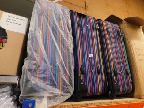 Three Beverly Hills multi stripe suitcases.