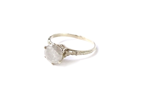 A diamond solitaire ring, with round brilliant cut diamond approx 1.22cts, in white claw setting, with white shank and leaf design shoulders, on a yellow metal band, stamped 14K, ring size M, 1.52g all in. With previous insurance valuation for NRV of £1,