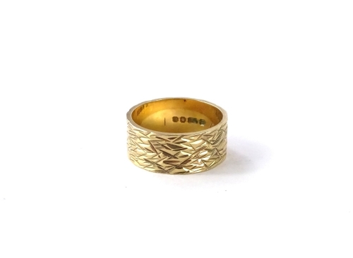 A 9ct gold thick wedding band, with etched abstract design, makers stamp PHW, London assay, ring size M½, 4.5g.