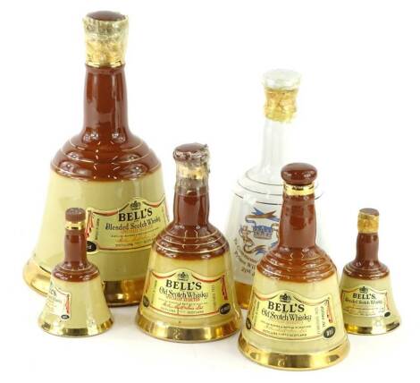 A bottle of Bell's whisky in a Wade decanter, similar commemorative bottle for the birth of Prince William of Wales, and four smaller examples.