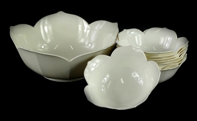 A cream coloured Melamine Liberty dessert set, modelled in the form of a flower head, comprising large fruit bowl and eight smaller bowls, the largest stamped Liberty.