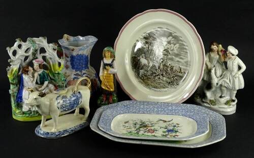 A collection of ceramics, to include two Staffordshire figures, a willow pattern cow creamer, a Masons type Hydra jug, continental majolica figure of a lady, etc.