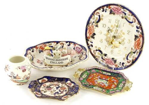 A collection of Mason's Ironstone, to include Mandalay pattern wall clock, a shaped dish, Ironstone plaque, three Masons figural small vases or candle holders, and a Oriental lake pattern two handled tray.