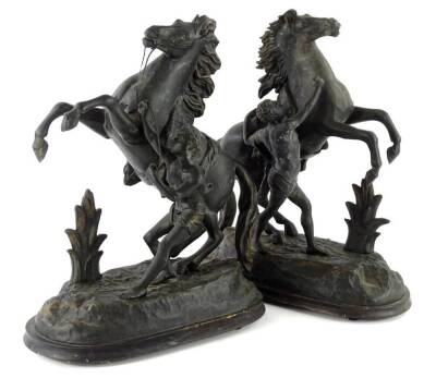 A pair of ebonised spelter Marley horses, each modelled in the form of a rearing horse with attendant, on a shaped rectangular base, 32cm W.