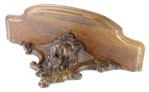 A Victorian walnut wall bracket, carved with a lion, with a moulded shaped shelf, 62cm W.