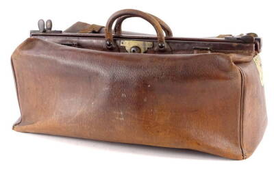An early 20thC brown leather Gladstone bag stamped A Davis and Co, makers Strand London, bearing label for the chosen government railways of the South Korea, 64cm W.