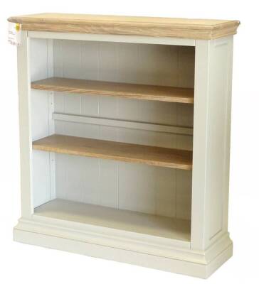 An ex shop display Edinburgh low bookcase, with a lined frieze and drawers, and pale grey painted caucus, 100cm W, retail price was £567.60 reduced to £283.80.