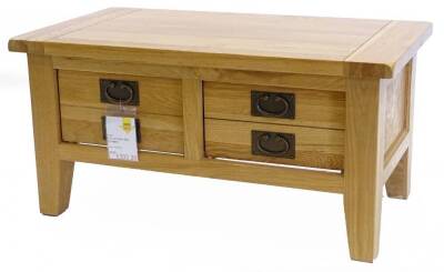 An ex shop display rustic four drawer oak coffee table, on square tapering legs, 90cm W, retail price was £644.40 reduced to £332.20.