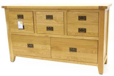 An ex shop display Hampton Court oak chest or small sideboard, with three frieze drawers above four deeper drawers, on bracket feet, 118cm W.