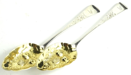 A pair of George III Old English pattern spoons, later converted to berry spoons, each with gilt bowls and engraved handles, bird crest, London 1807, 5¼oz.