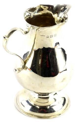 A George V silver baluster shaped cream jug, with sparrow beak type spout and shaped handle on domed foot, (AF), Birmingham 1919, 3½oz.