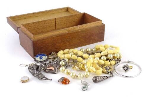 A quantity of modern costume jewellery and effects, to include faux pearl necklaces, on 9ct gold clasp, modern dress rings, a silver curb link watch chain and fob, elaborate dress earrings, bone necklace, etc. (1 box)