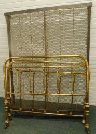 A late Victorian brass bed head and foot, with turned rails, on ceramic castors, and with iron frame, 38cm W. (4ft 6)