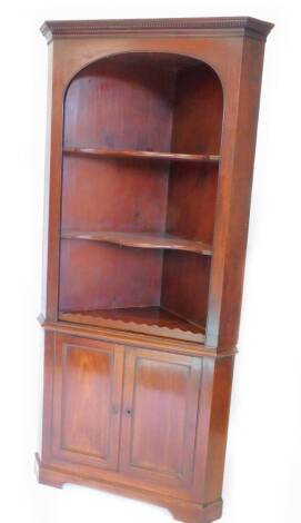 A 19thC mahogany corner cabinet, the top with a dental cornice above two open and shaped shelves, the base with two panel doors on bracket feet, 212cm H, 99cm W.