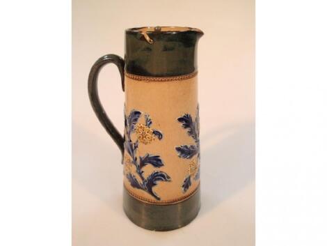 A Doulton Lambeth stoneware tapered cylindrical jug decorated in relief