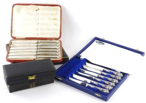 Three sets of six silver handled dessert knives, each in a fitted case.