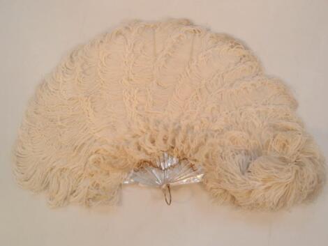 An early 20thC ostrich feather and mother-of-pearl fan