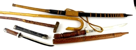 A collection of swords, to include Eastern example with broad scabbard with point to one end, indistinctly signed, the handle with woven handle, terminating in brass caps, a souvenir sword with carved scabbard and handle, a small Japanese type sword, a sh