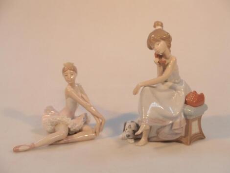 A Lladro figure group of a young seated girl with telephone and a dog at her feet