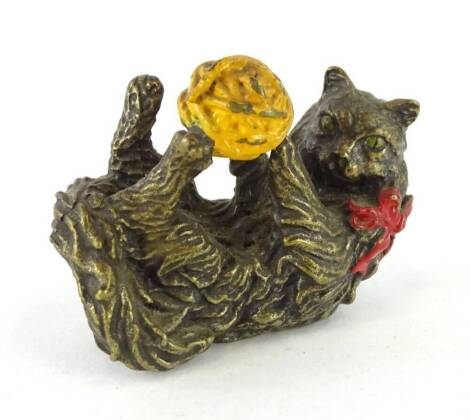 A cold painted bronze figure of a kitten or cat playing with a ball of wool, in the manner of Bergman, 6cm L.