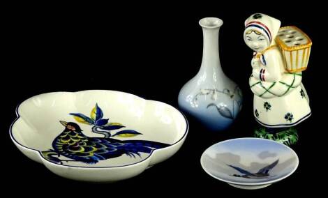 Four items of Danish porcelain, to include a Copenhagen small pin tray, decorated with a mallard in flight, a Copenhagen blue pheasant pattern dish, a Copenhagen type vase, decorated with snow drops, and a Jus holder modelled in the form of a lady in Dani