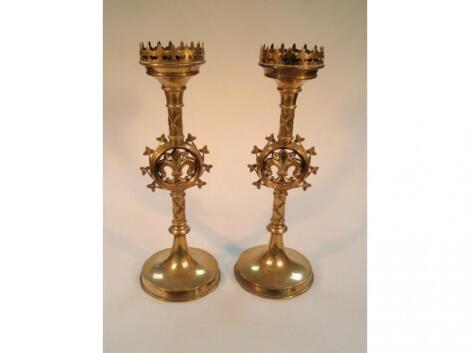 A pair of late 19thC brass altar candlesticks with castellated sconces