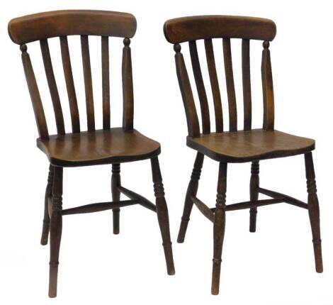 A pair of 19thC lathe back ash and elm kitchen chairs, on turned legs with H stretcher.