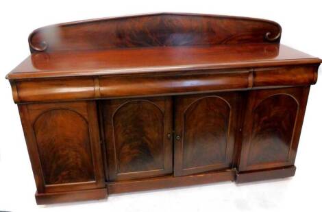 A Victorian figured mahogany sideboard, with a raised arched back, a moulded edge above an arrangement of three drawers, and three panel doors, on inverted breakfront plinth, 186cm W.