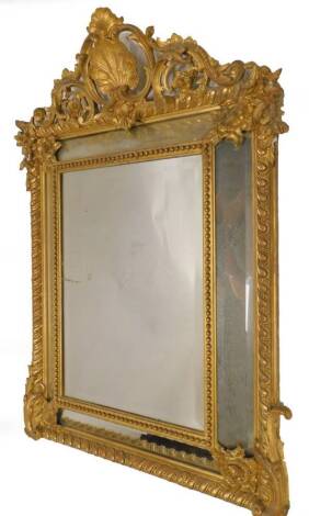 A 19thC continental gilt gesso wall mirror, the pierced crest decorated with shells, c scrolls, etc., above a central rectangular bevelled plate, surrounded by four further plates, the frame decorated with gadroons, beads, and scrolls, etc., 119cm x 85cm.