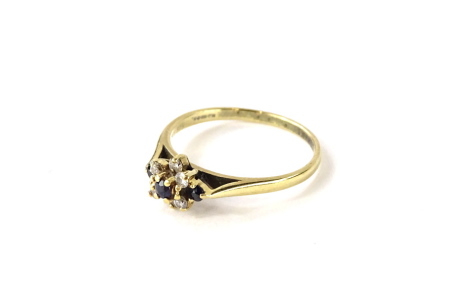 A 9ct gold dress ring, of floral cluster design set with white and blue stones, each in claw setting, ring size M½, 2g all in.