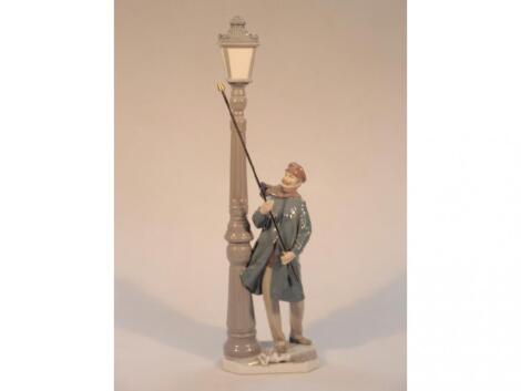 A Lladro figure of a lamp lighter with lamp