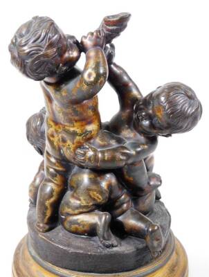 A pair of bronze groups of putti, one featuring a central putto blowing a horn, a second reaching up, a third on all fours beneath, circular base, on a circular brass socle, the other with standing putto holding a leaf, 28cm H. - 4