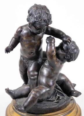 A pair of bronze groups of putti, one featuring a central putto blowing a horn, a second reaching up, a third on all fours beneath, circular base, on a circular brass socle, the other with standing putto holding a leaf, 28cm H. - 6