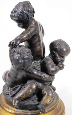 A pair of bronze groups of putti, one featuring a central putto blowing a horn, a second reaching up, a third on all fours beneath, circular base, on a circular brass socle, the other with standing putto holding a leaf, 28cm H. - 7