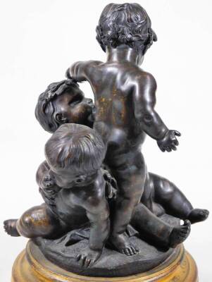 A pair of bronze groups of putti, one featuring a central putto blowing a horn, a second reaching up, a third on all fours beneath, circular base, on a circular brass socle, the other with standing putto holding a leaf, 28cm H. - 8