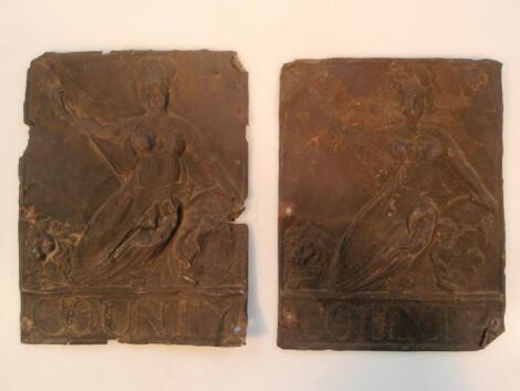 Two old pressed metal fire marks