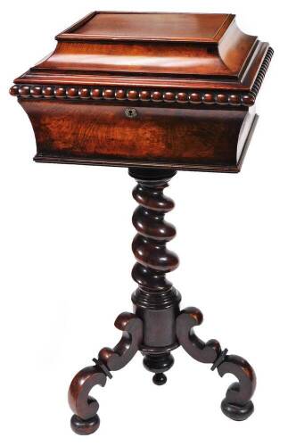 A early Victorian rosewood and mahogany teapoy, the rectangular sarcophagus top with an elongated beaded border, revealing a fitted interior with removable caddy boxes and openings for bowls, on a barleytwist stem terminating in scroll legs on compressed