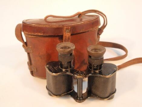 A pair of WWI binoculars in a leather case