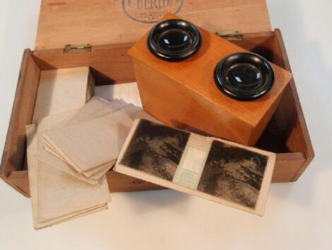 A vintage boxwood hand held stereoscopic viewer and a collection of slides