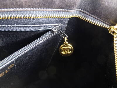 A Chanel quilted leather tote bag, in black, with over stitched CC logo to front and gold medallion embellished zipper, serial code to interior worn, serial code on authenticity card 8687435 (2003-2004), 25cm H, 32cm W, 14cm D. - 4